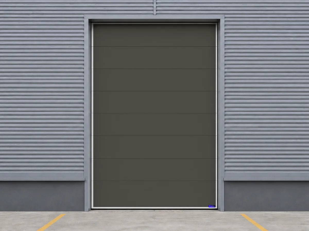 Porte sectionnelle industrielle gris terre pour un bâtiment professionnel